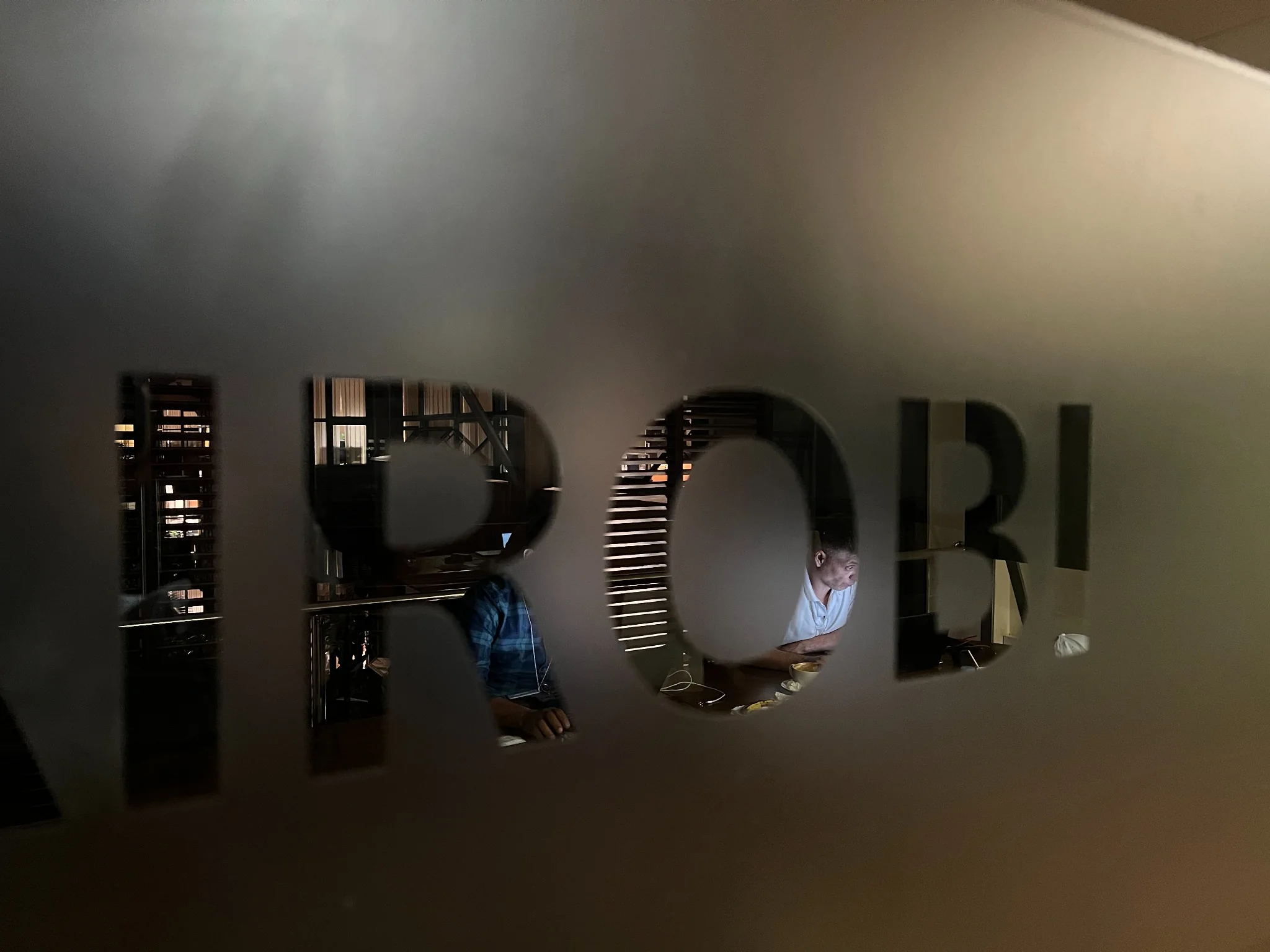 Late-night work in Nairobi with Aleksandr Shestakov's developer team behind the frosted glass letters