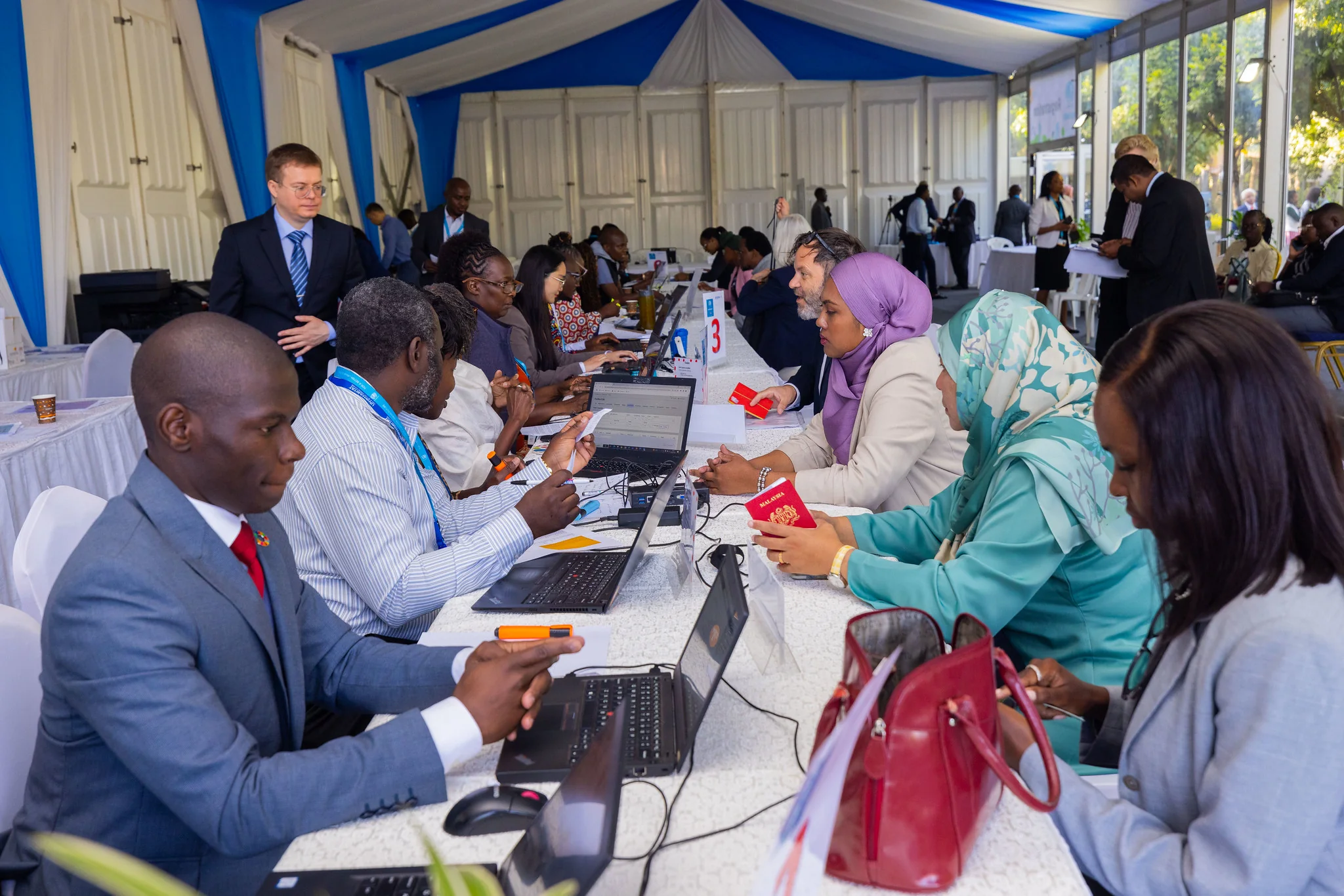 Registration team at work inside the UNHA2 tent while Aleksandr Shestakov checks the operation