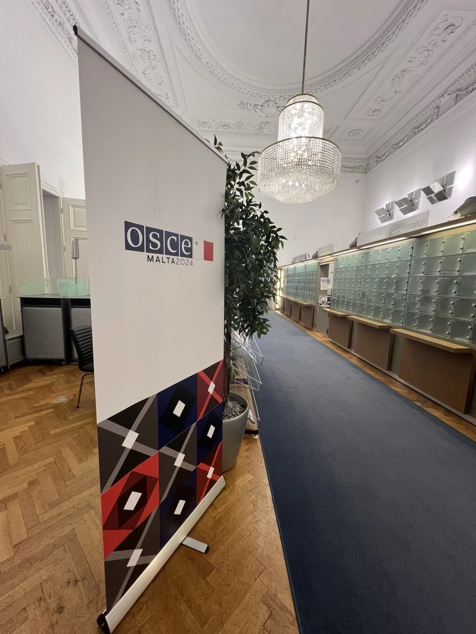 OSCE Malta 2024 signage inside the Hofburg